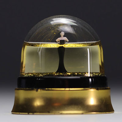 JEAN PAUL GAULTIER snow globe decorated with gold sequins representing a woman wearing a long black dress