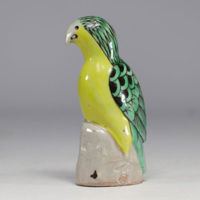 China - Green and yellow glazed ceramic parrot, perched on a rock, Qing period.