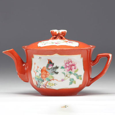 Famille rose porcelain teapot decorated with flowers on a coral background