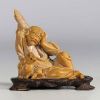 China - Hard stone sculpture of a figure with a lion on a wooden base.