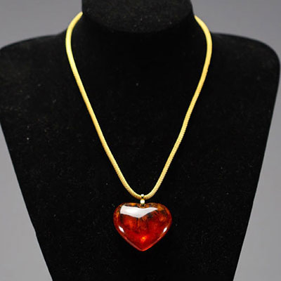 Yves SAINT LAURENT - Heart necklace, imitation amber and gold-plated metal, signed.