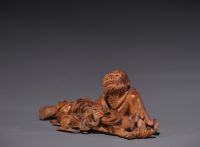 Japan - Boxwood sculpture of a reclining old man, late 19th century.