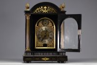 Mantel clock with striking mechanism in veneered wood, bronze and brass, 18th century.