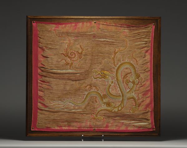 China - Embroidered silk tapestry decorated with a gold dragon on a pink background, late 19th century.