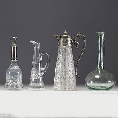 Set of four glass, cut crystal and silver-plated metal decanters.