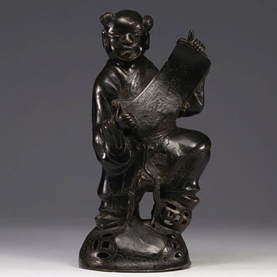 China - bronze sculpture of a young boy carrying a scroll.