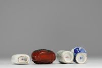 China - Set of three porcelain snuffboxes and one in multi-layered glass.