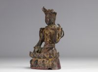 Statue of a traditional seated figure in bronze originating from China from the Ming period  (明朝)