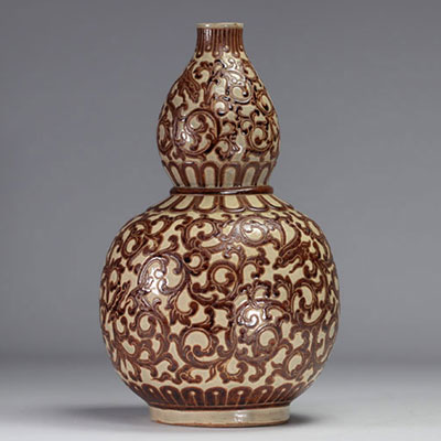 Indochina - ochre and green glazed ceramic gourd vase decorated with foliage, 1930