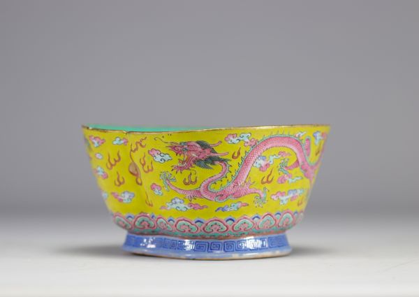 A Famille Rose porcelain bowl decorated with imperial red dragons on a yellow ground with the mark and of the Tao Kuang period (1821-1850)