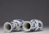 China - Pair of blue-white porcelain vases with figures, Kangxi mark, 19th century.