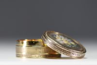 A solid silver snuffbox with a guilloche motif, the lid containing a miniature of flowers.