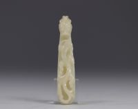 China - Pale celadon jade fibula decorated with Qilong dragons walking among stylised plants