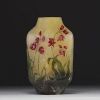 DAUM Nancy - Vase losange en verre multicouche dégagé à l'acide à décor floral émaillé, signé.