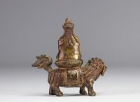 An ormolu Guanine sculpture resting on a lion from the Qing period (清朝)