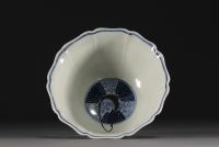 China - Bowl on foot in blue-white porcelain decorated with dragons in waves, Xuande mark.