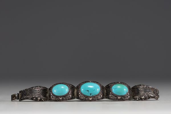 China - Solid openwork silver bracelet with two large turquoise stones.