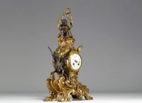 A 19th century ormolu and patinated clock decorated with a Putto and a winged dragon.