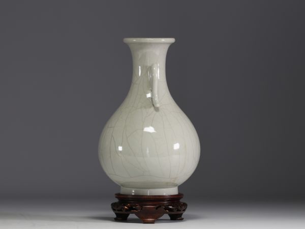 China - Monochrome porcelain vase on wooden base, blue mark under the piece.