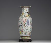 China - A rare pink family polychrome porcelain vase with relief decoration of domestic objects, fruit and floral motifs, hexagonal base, 19th century.