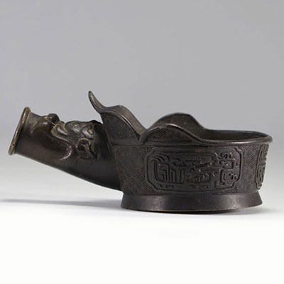 Bronze iron decorated with archaic motifs dating from the 13th century - the moulding has the head of a dragon