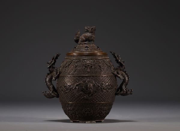 China - Bronze perfume burner decorated with dragons, lid surmounted by a Fô dog.