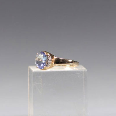 Gold ring with blue topaz and diamonds in the center