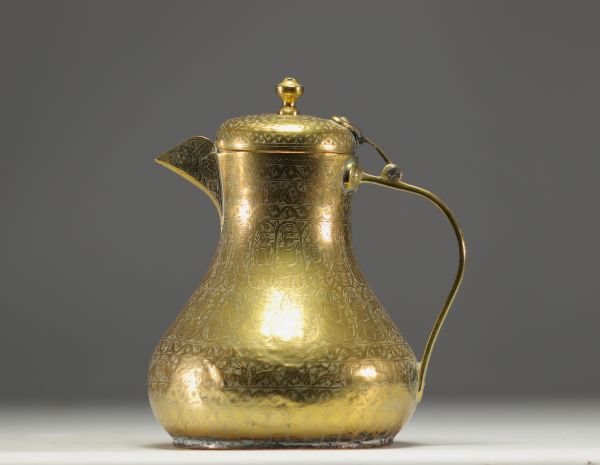 Persian coffee pot in chased brass with animal and figure motifs.