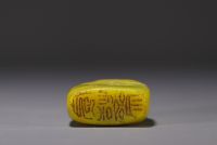 China - Yellow stone seal carved with a figure in a landscape and engraved with a poem.