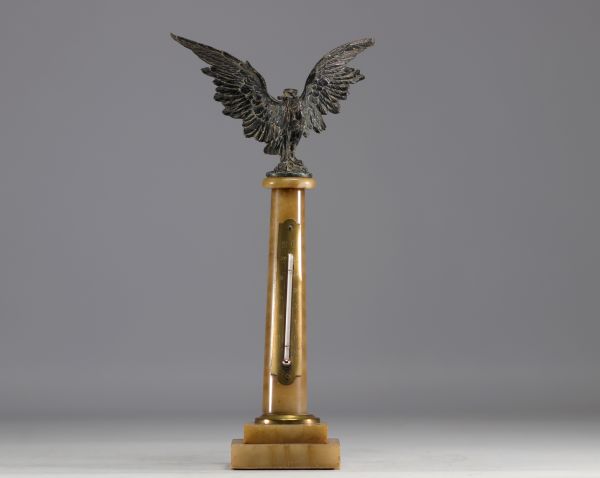 Watch and thermometer holder on marble column surmounted by an eagle in regula, late 19th century.