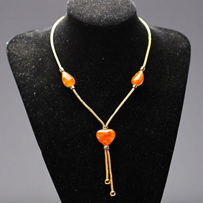 Yves SAINT LAURENT - Heart and drop necklace in imitation amber and gold-plated metal, signed.