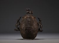 China - Bronze perfume burner decorated with dragons, lid surmounted by a Fô dog.