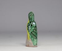 China - Green and yellow glazed ceramic parrot, perched on a rock, Qing period.