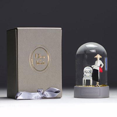 CHRISTIAN DIOR snow globe representing a model posing next to an armchair in the company of her teddy bear from 1947