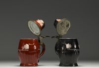 A pair of figurative porcelain mugs with lithophanied bases, by Eduard Kick in Amberg, 19th century.