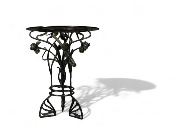 Glass table with floral wrought iron base, Art Nouveau period.