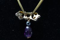 Christian LACROIX - Necklace, violet stone drop and gilded metal pearl, signed.